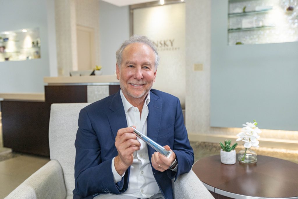 Photo of Dr. Mark Pinsky from Florida holding Trace + Erase that was produced in collaboration with Serious Skincare.  The key ingredient is the globally patented DermaTriPlex™.